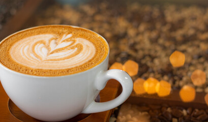Latte art coffee with bokeh of lights on table, Dark tone.