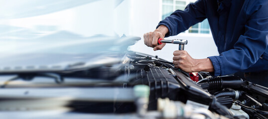 Car service , Professional mechanic working on the engine , repairing a car engine automotive workshop with a wrench, car service and maintenance ,Repair service. - obrazy, fototapety, plakaty