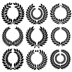 Obraz premium vector set of black laurel wreaths, featuring circular foliate laurel branches. The designs include a variety of laurel wreath silhouettes, represen.