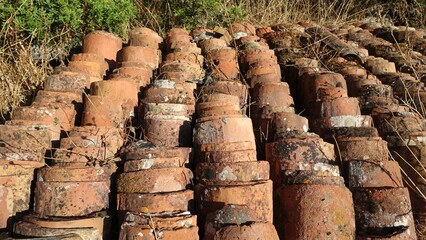 Hundreds of antique roof tiles piled in a row ready to be used for a new home.