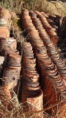 Hundreds of antique roof tiles piled in a row ready to be used for a new home.