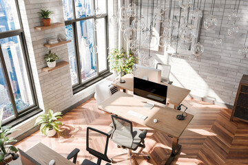 luxurious loft apartment with floor-to-ceiling windows and panoramic view; modern minimalistic interior design of workspace, top down view, home office area; bright daylight; 3D rendering