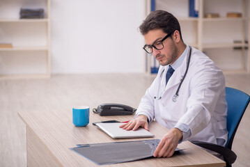 Young male doctor radiologist working in the clinic