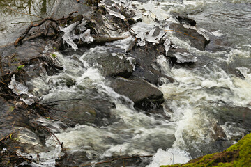 cold water flows over the stones