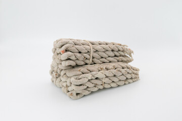 Bundles of rope incense made of mixtures of Himalayan herbs shot on white background