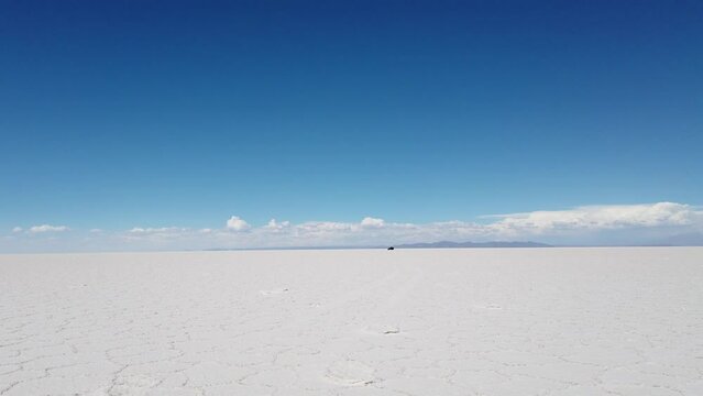 A car driving across the Salt Flats in Bolivia.