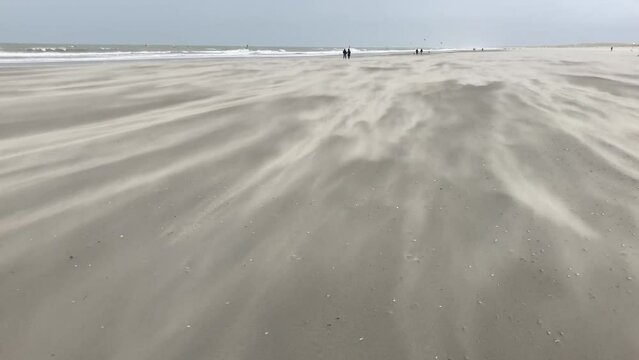 Storm blowing sand across a beach on the dutch North Sea coast