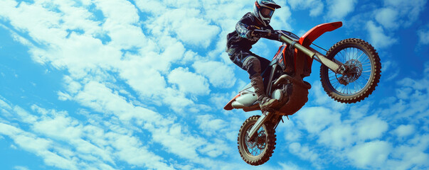 Daring motorcycle stunt in mid-air, showcasing an off-road motocross motorbike during a thrilling jump on a dirt trail. - obrazy, fototapety, plakaty