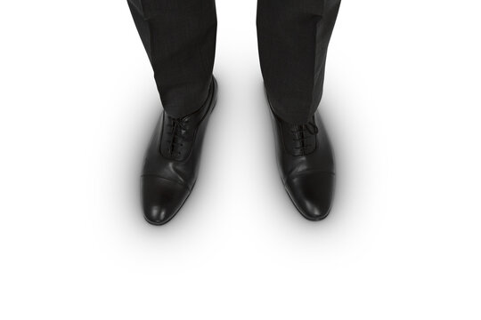 Top view of businessman's black shoes on white surface, corporate attire