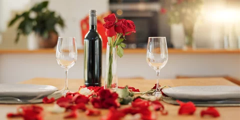 Fotobehang Eetkamer Wine, flowers and romance on valentines day for celebration of love, anniversary or honeymoon in still life. Glass, dinner and elegant date in dining room of home for event, milestone or occasion  © Felix/peopleimages.com