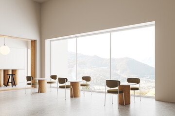 Beige modern cafe interior with chairs and table near panoramic window