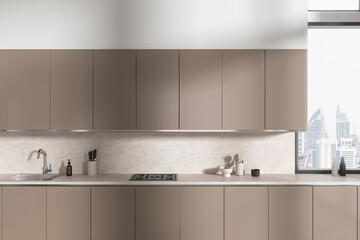 Fototapeta na wymiar Beige home kitchen interior with cooking cabinet and panoramic window