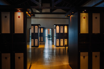 Sotogrante, Spain - January 27, 2024 - Dimly lit corridor with wooden lockers on both sides,...