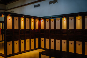 Sotogrante, Spain - January 27, 2024 - Row of wooden lockers with illuminated panels in a dimly lit...