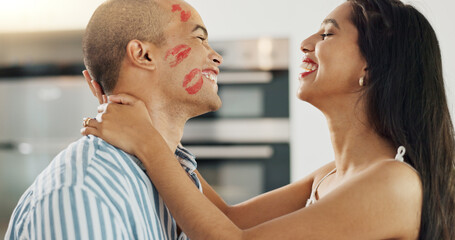 Happy couple, love and kiss with lipstick for fun date and playful at home in intimacy, romance and...