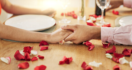 Couple, roses and holding hands on dinner date, anniversary or valentines day dining by table at...