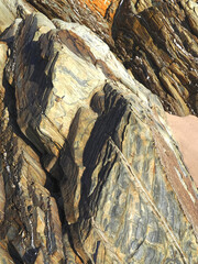 Colorful slate natural rocks at the beach of Vila Nova de Milfontes in Portugal