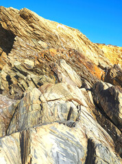 Colorful slate natural rocks at the beach of Vila Nova de Milfontes in Portugal