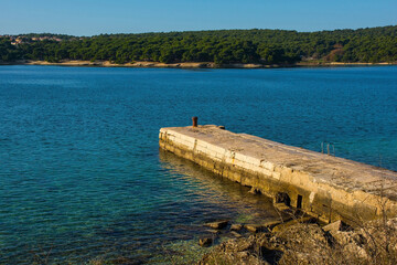 A pier on the coast of Kasteja Forest Park - Park Suma Kasteja - in Medulin, Istria, Croatia....