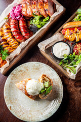 fast food set on plate. various meat Bavarian, Frankfurt, German grilled sausages and vegetables
