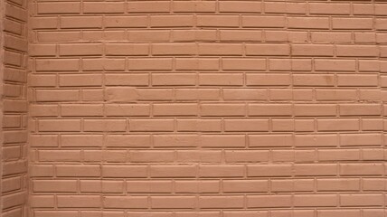 Brick masonry painted in a warm color with an aged texture as a background with an empty copy of the spaces, a graphic resource with an abstract pattern of bricks