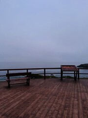 Fototapeta na wymiar twilight at the ocean coast, dark sky, foggy and misty ocean view, point of view, no people