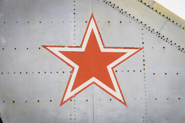 Red soviet star serving as nationality marking at the exterior of a retired military fighter jet of the Russian Air Force