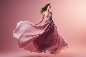 Woman in pink dress, fashion model in silk dress fluttering in the wind, fantasy girl in flying fluttering fabric