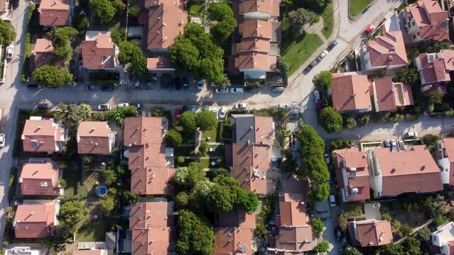 Aerial Establishing Shot above European Countryside Neighborhood Gardens Pools for Swimming and Cars Driving By. High quality 4k footage