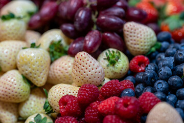 white strawberries with raspberries and black blueberries and blackberries