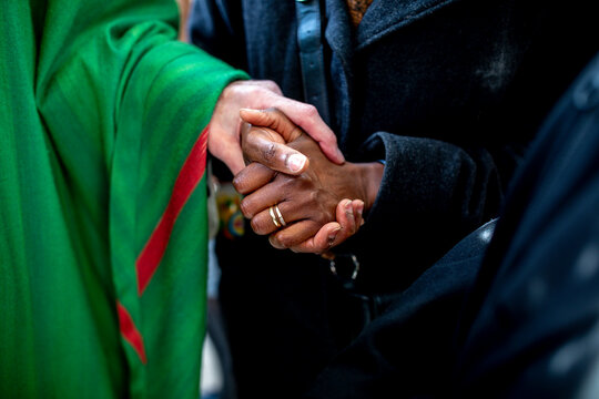 Catholic priest meeting parishioners after mass in Paris, France