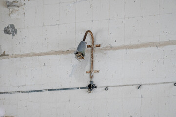 Remnants of History: Decaying House with Wall-Mounted Lamp. Decaying Beauty: Wall-Mounted Lamp in Abandoned Building. Soviet Era Heritage: Abandoned Building Remnants. 