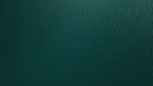 Calm zen therapeutic ocean wave nature patterns with gentle soft sunlight on green Caribbean water