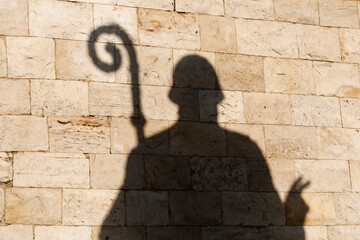 Shadow of a statue of Saint Nicolas outside the basilica in Bari, Italy
