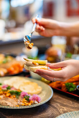 woman's hands spreading liver pate on toast bread