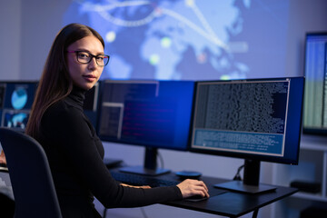 Female IT Consultant in cyber security team working to prevent security threats, find vulnerability...