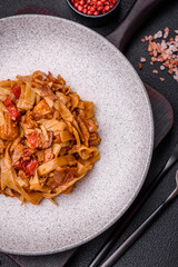Delicious asian udon dish with vegetables, mushrooms, salt and spices