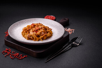 Delicious asian udon dish with vegetables, mushrooms, salt and spices