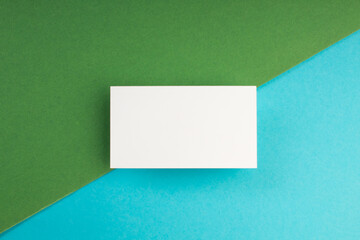 Business card blank over colorful background. Copy space for text. Top view.Business card blank over colorful abstract background. Corporate stationery branding mock-up. Copy space for text. Top view.