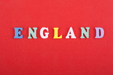 Fototapeta na wymiar ENGLAND word on red background composed from colorful abc alphabet block wooden letters, copy space for ad text. Learning english concept.