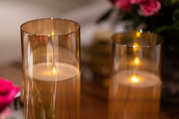 Tables served withcandles and rose petals for a dinner. Celebration, holiday,  wedding, decor