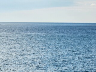 Corniglia, 5 Terre, Italy - January 05, 2024: Beautiful photography of the Cinque Terre landscape. Spectacular view of the waves with blue sky in the background in winter days. Sunset colours.