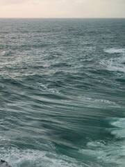 Corniglia, 5 Terre, Italy - January 05, 2024: Beautiful photography of the Cinque Terre landscape. Spectacular view of the waves with blue sky in the background in winter days. Sunset colours.