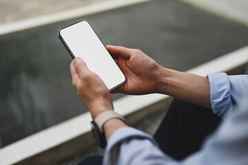 Cropped image of Businessman using a smartphone at outdoor, Empty screen of smartphone