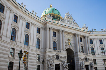 Opera house building in Austria. Viennese architecture. A beautiful building with a large green dome combined with golden elements. Gold color in architecture. Color combinations in architecture.