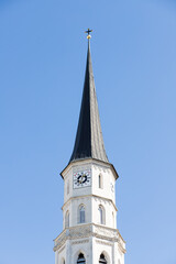 Fototapeta na wymiar Chapel against the sky in Austria. The building of the Austrian Town Hall in the center of the capital. Clock on the tower of the building. Beautiful facade in Gothic style. Gothic architectural struc