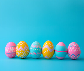 Fototapeta na wymiar Colorful Easter eggs aligned on blue background, space for text 