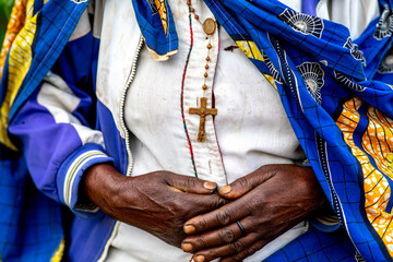 Woman wearing a cross standing in a village in northern Rwanda