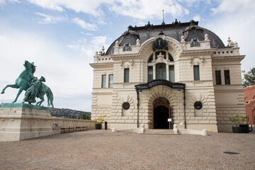 Landmark of Budapest. Entrance to the palace with a beautiful facade. Monument near the entrance to Lvorets. Stylish architecture of a big city. Historical building with a beautiful entrance. Royal