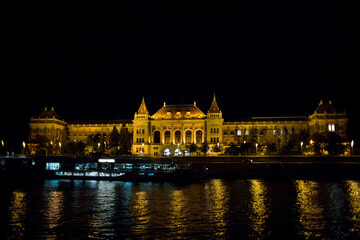 Castle on the shore of Budapest at night. Evening in the capital of Hungary. Panoramic view of the palace. A place to relax on the banks of the Danube River. View of Budapest at night.